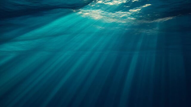 Sunlight Illuminated Underwater Scene Showcasing Serenity, Water Depth, and Calm Blue Oceanic View from Beneath