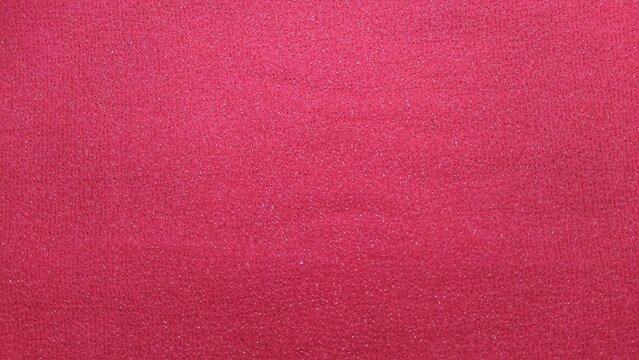 ​Red fabric texture background, bright pink magenta textile surface closeup.