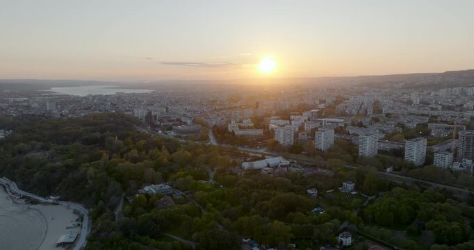 Panoramic cityscape Varna Bulgaria Chaika district sunset light. Drone perspective residential buildings sea horizon. Summer golden hour urban landscape Balkan architecture