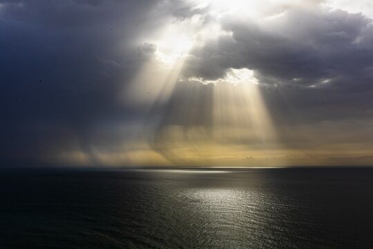 Sunbeams breaking through storm clouds over Mediterranean Sea