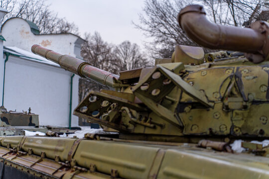 View of a olive-green military tank stands stoically against a stark white building, an emblem of strength and resilience, Kyiv, Kyiv, Ukraine.