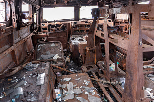 View of the skeletal remains of a vehicle's interior, a haunting tableau of destruction with shattered glass and twisted metal, Kyiv, Kyiv, Ukraine.
