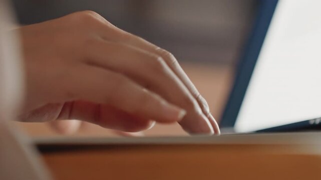 Fingers tap keyboard. Nighttime writing in cozy suite. Gentle illumination creates serene environment for creative writing. Intimate scene of fingers poised over keys in peaceful hotel setting