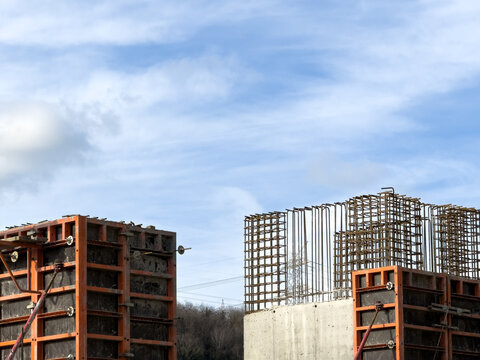 View of concrete structures rising against a bright sky, framed by wooden forms, showcasing the raw beauty of urban development, Istanbul, Istanbul, Turkey.