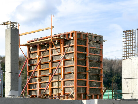 View of raw concrete pillars rise against a backdrop of construction materials, hinting at urban development in Sariyer, Istanbul, Turkey.