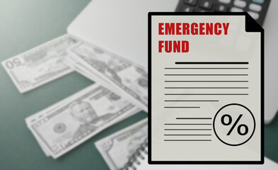 dollar bill on top and the word emergency fund written on it