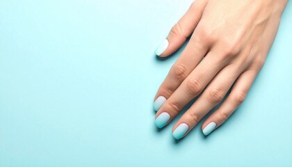 Fototapeta premium Elegant Woman Hand with Pastel Blue Nails on Soft Blue Background.
