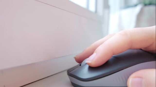 Close up of hand using computer mouse in bright office setting intense office work digital tasks and modern work routine