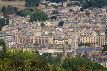 Fototapeta premium A cityscape view of Bath's honey-colored stone buildings, featuring Bath Abbey and church spires, England