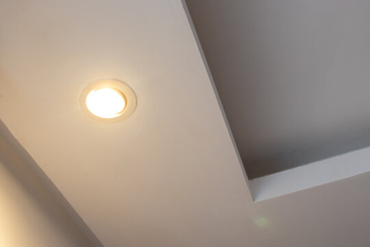 Detail of recessed ceiling lighting with LED spotlights lit in a residential interior. 