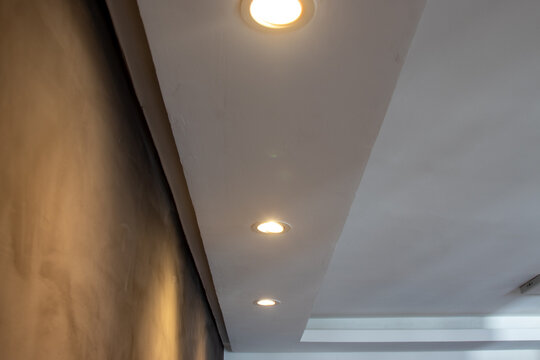 Detail of recessed ceiling lighting with LED spotlights lit in a residential interior. 