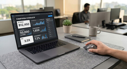 Person working on a laptop displaying a digital marketing campaign overview with ad spend traffic conversions and roi