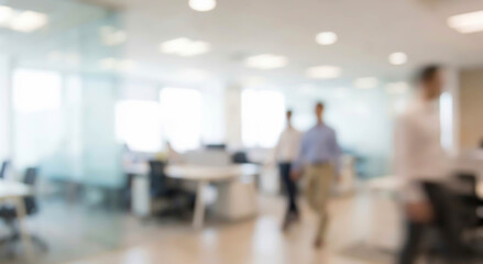 Fototapeta premium Blurred image of an office environment with multiple people walking in the background. Desks and chairs are visible, creating a busy yet professional atmosphere.