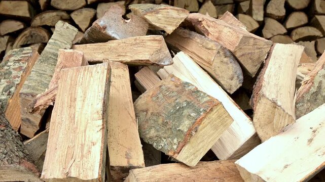 person throwing cut firewood logs