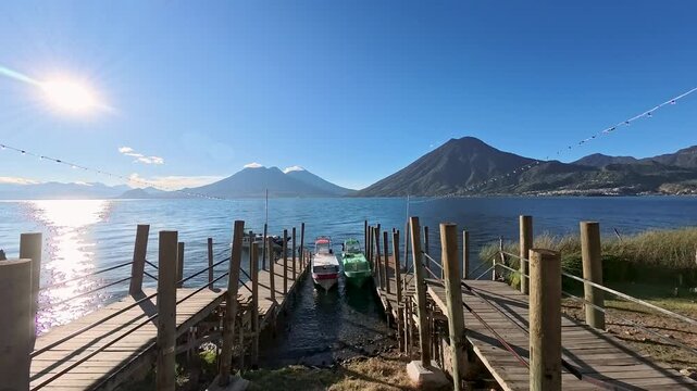 
Panajachel, Guatemala,  piers on Lake Atitlan with panorama of volcanoes on a sunny day