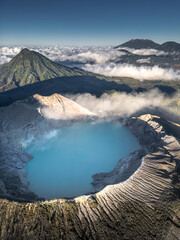 Naklejka premium A stunning aerial view of the Kawah Ijen volcano crater tranquil scenery of a blue lake in the mountains
