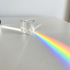 Glass Prism Dispersing White Light into a Vibrant Rainbow Spectrum on a Minimalist Surface