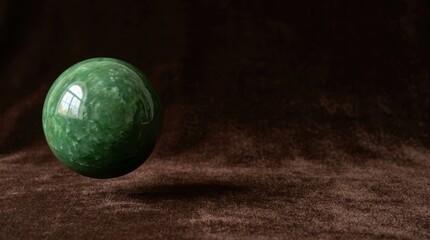 Floating Polished Green Jade Marble Sphere Over Brown Velvet Texture Minimalist Concept Still Life