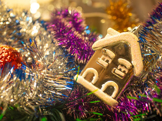 Christmas bauble hanging on shiny tinsel background