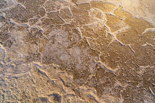 the texture of a mixture of sand, earth, clay, and snow on Lake Elton