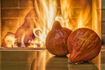 Cozy fireplace,winter vacations, pumpkins on the table, fire burning