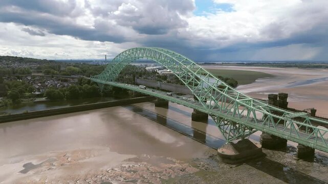 Liverpool, Merseyside, UK, September 09, 2025; aerial 4K video footage of the Silver Jubilee Bridge and Britannia Railway Viaduct over the River Mersey and Manchester Ship Canal, Runcorn, Merseyside
