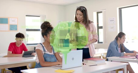 Fototapeta premium Standing teacher in shades helping student in class, guiding silver laptop with letter A overlay