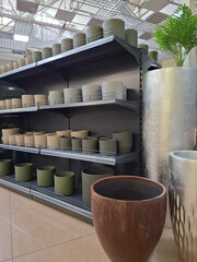 Fototapeta premium Flower pots on supermarket shelves. Many ceramic products in flower shop