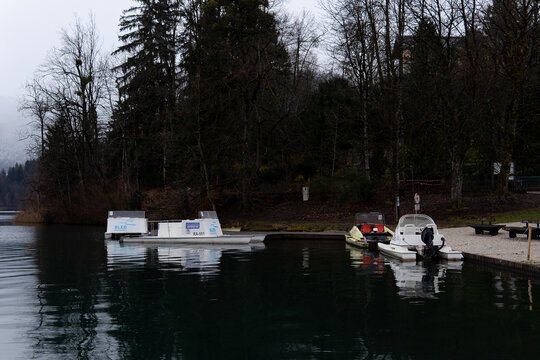 Lake Bled with boats in winter, Slovenia, calm waterscape, December 2025