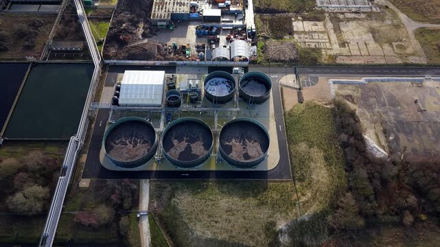 Aerial view of the Lenzing Fibers Grimsby featuring large circular tanks, and industrial infrastructure, creating a textured landscape, Grimsby, England, United Kingdom.