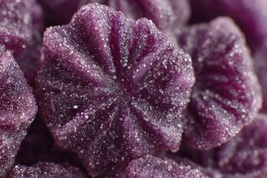 A close-up shot of a cluster of delicious, vibrant purple gummy candies, dusted with sugar, creating a tempting and visually appealing treat perfect for dessert lovers.
