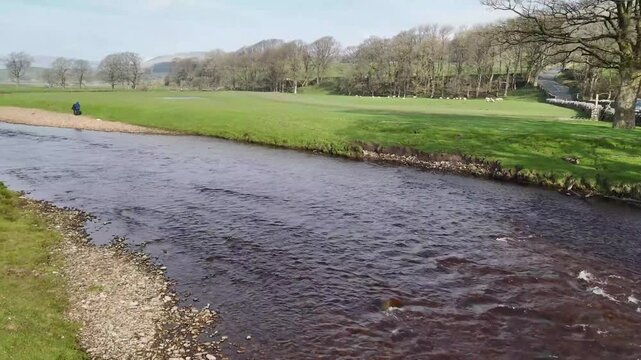 Aerial view over the River Ure in Hawes from a drone 4K video