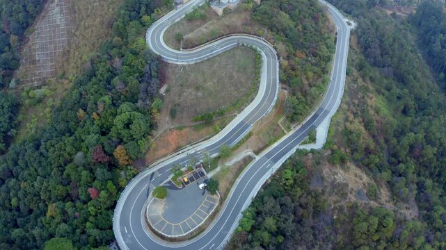Winding Mountain Highway Through Forest Aerial View