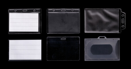Plastic ID Badge Holders with Blank Inserts on Black Background. Assorted clear and black plastic...