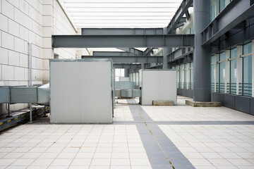 Naklejka premium Modern building rooftop equipment room corridor with steel framework and ventilation units