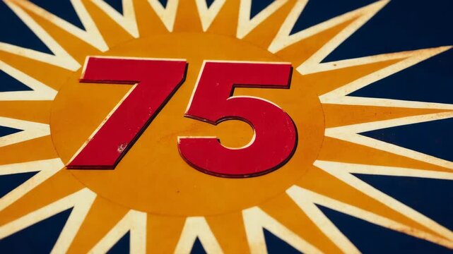 A close look at the number 75 on a sign with a star pattern in a bright color scheme during daylight