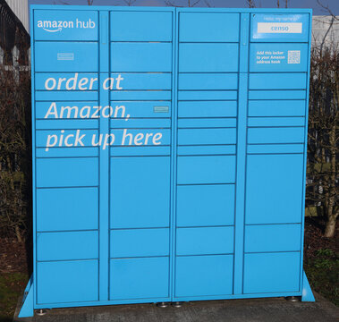 Norwich, England: March 4 2026: Historic buildings and street architecture in Norwich city centre Norfolk. Large blue amazon hub locker unit for package pickup and delivery