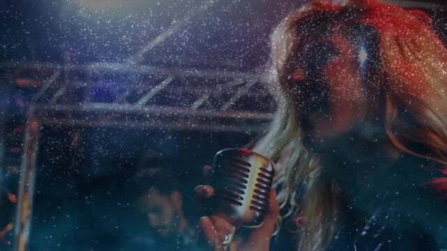 Music singer onstage leaning into mic, breathing causing zooming revealing guitar, spark over her