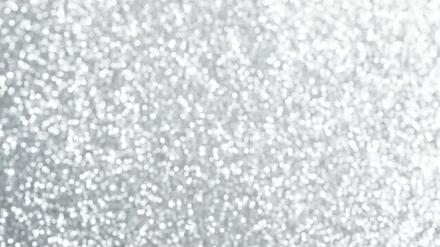 Sparkling silver glitter background with a soft focus effect, perfect for festive designs and celebrations.