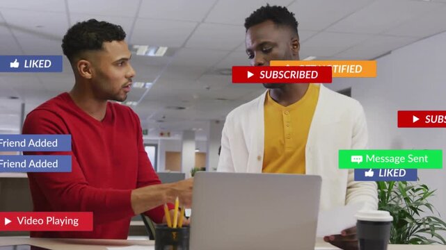 Two male colleagues working in business, laptop getting overlays covering them, pointing, reviewing