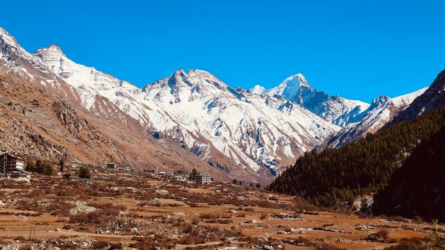 Himalayan Snow Mountains and Remote Valley Village, chitkul Under Clear Blue Sky