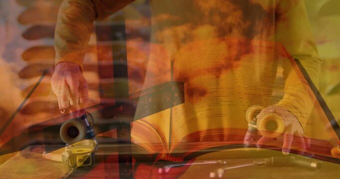 Hands using tool, mounting wheels fixing on board clear book orange flame overlay supporting design