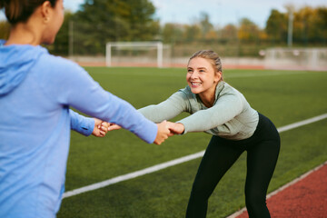 Women partners stretching together after outdoor workout