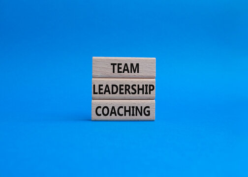 Team leadership coaching symbol. Concept word Team leadership coaching on wooden blocks. Beautiful blue background. Business and Team leadership coaching. Copy space