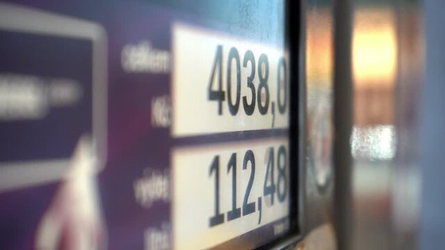 Gas station fuel price board with changing digital numbers. Close-up view symbolizing fuel price fluctuations, energy inflation and market volatility affecting transportation and daily mobility.