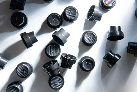 Black spray can caps with dramatic shadows, graffiti background texture