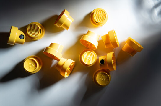 Yellow spray can caps with dramatic shadows, close up detail