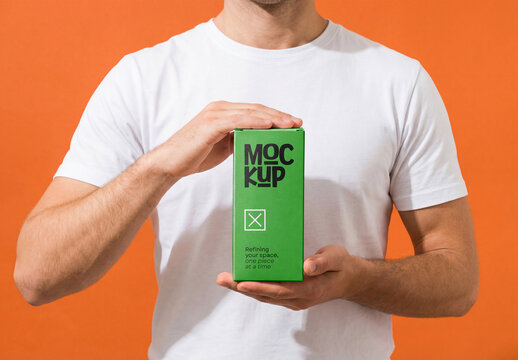 Person Holding Green Vertical Product Packaging Box Mockup