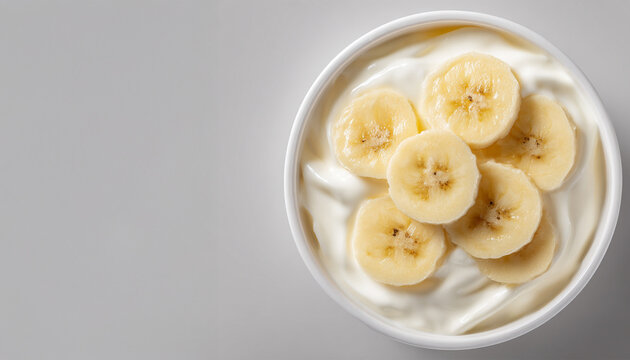 Fresh homemade simple banana yogurt in white bowl on light background, Copy space. Healthy breakfast