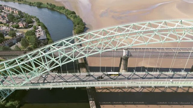 Liverpool, Merseyside, UK, September 09, 2025; aerial 4K video footage of the Silver Jubilee Bridge and Britannia Railway Viaduct over the River Mersey and Manchester Ship Canal, Runcorn, Merseyside